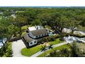 Expansive aerial view of a two-story home with a pool, surrounded by lush trees and a spacious yard at 5307 22Nd W Ave, Bradenton, FL 34209