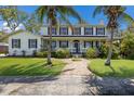 Charming two-story home featuring a welcoming front porch, well-manicured lawn, and lush landscaping at 5307 22Nd W Ave, Bradenton, FL 34209