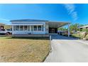 Bright single-story home with a carport and well-maintained lawn at 5619 Bayshore Rd # 423, Palmetto, FL 34221