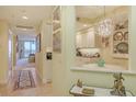 Hallway view of dining room and kitchen with charming decor and water view beyond at 611 Riviera Dunes Way # 107, Palmetto, FL 34221