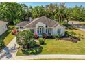 Beautifully landscaped home featuring vibrant landscaping, well-manicured lawn, and inviting front entrance at 6602 Peach Tree Creek Rd, Bradenton, FL 34203