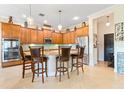 Gourmet kitchen with granite countertops, stainless steel appliances, and center island at 750 116Th Ne Ct, Bradenton, FL 34212