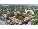 Aerial view of condo complex with pond, pool and lush landscaping in a desirable community at 850 S Tamiami Trl # 207, Sarasota, FL 34236
