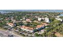 Aerial view of a condo complex surrounded by lush greenery and a view of a lake and water at 850 S Tamiami Trl # 207, Sarasota, FL 34236