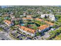 Panoramic aerial view of the condo community with a scenic pond, pool, and recreational facilities at 850 S Tamiami Trl # 730, Sarasota, FL 34236