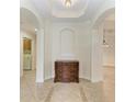 Inviting home foyer featuring tiled floors, decorative arches, and a stylish wood dresser at 9429 Discovery Ter # 102B, Bradenton, FL 34212