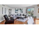 A cozy living room with modern furniture, wood floors, a decorative rug and a balcony at 1000 Longboat Club Rd # 604, Longboat Key, FL 34228