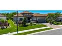 Beautiful home featuring a two-car garage, stone accents, and a well-maintained lawn at 10510 Giddens Pl, Palmetto, FL 34221