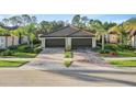 Gorgeous home with a three-car garage, meticulously maintained landscaping, and a stylish paver driveway for curb appeal at 12091 Amica Loop, Venice, FL 34293