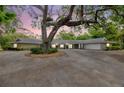 Charming single-story home featuring well-maintained exterior, circular driveway, and mature landscaping at 1240 Fox Creek Dr, Sarasota, FL 34240