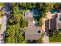 Aerial view of a home with a swimming pool, patio area, and meticulously landscaped backyard, offering a private oasis at 1434 Ladue Ln, Sarasota, FL 34231