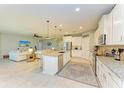 Bright, open kitchen features a granite island, stainless appliances and leads into a cozy living room at 15612 Trinity Fall Way, Bradenton, FL 34212