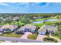 Expansive aerial view of the home, showcasing its proximity to the golf course and lake at 2020 Calusa Lakes Blvd, Nokomis, FL 34275