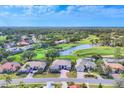 Beautiful aerial view showcasing the home's location near a golf course and serene lake at 2020 Calusa Lakes Blvd, Nokomis, FL 34275