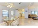 Bright dining area featuring a glass table, four chairs, and wood-look flooring at 216 Palm Air Dr, Osprey, FL 34229