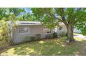 Well-maintained single-story home featuring a green lawn and mature landscaping at 218 80Th N Ave, St Petersburg, FL 33702