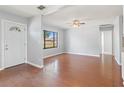 Inviting living room with hardwood floors, ceiling fan, and ample natural light at 218 80Th N Ave, St Petersburg, FL 33702