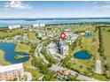 Property aerial view with a coastal backdrop and surrounding golf course, ponds, and a beautiful residential neighborhood at 2320 Terra Ceia Bay Blvd # 305, Palmetto, FL 34221