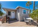 Charming beach house featuring a cozy deck with seating, perfect for outdoor relaxation at 2601 Gulf N Dr # B24, Bradenton Beach, FL 34217