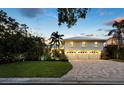 Beautiful two-story home featuring a pristine lawn and a three-car garage at 3322 Bayou Rd, Longboat Key, FL 34228