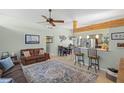 Cozy living room featuring warm natural lighting, a plush rug, and views into the kitchen at 3526 Austin St, Sarasota, FL 34231