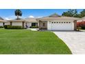Beautiful single-story home with a tile roof, well-manicured lawn and a two-car garage at 3606 Garden Lakes Clenet, Bradenton, FL 34203