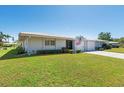 Quaint single-story home featuring a well-maintained lawn and an attached single-car garage at 3626 Medford Ln # 1537, Sarasota, FL 34232
