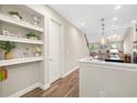 A charming kitchen with hardwood floors, a well-lit nook with shelves, and views into an airy room at 3644 Pitch Ln, Sarasota, FL 34232