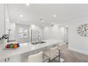 Modern all-white kitchen with sleek countertops, updated appliances, and ample cabinet space at 4390 Exeter Dr # 206, Longboat Key, FL 34228