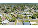 Aerial view of home with mature trees and a spacious yard nestled in a tranquil neighborhood at 507 Shore Dr, Largo, FL 33771