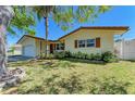 Charming single-story home with a well-kept lawn, beautiful landscaping and mature trees in a peaceful setting at 507 Shore Dr, Largo, FL 33771
