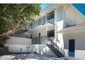 Modern building exterior with multiple stories, stairs and balcony at 5125 Gulf Of Mexico Dr # 4, Longboat Key, FL 34228