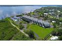 Aerial view of waterfront condos with tennis courts and beautifully landscaped grounds at 515 Leffingwell Ave # 209, Ellenton, FL 34222