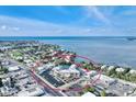 This aerial view shows the resort-style condo complex's proximity to the beach, water, and boating at 5325 Marina Drive # 423, Holmes Beach, FL 34217