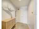 Condo entrance with a wooden latticework cabinet below a silver shark statue at 5325 Marina Drive # 423, Holmes Beach, FL 34217