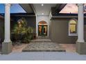 Inviting front entrance with double doors, decorative tiles, and elegant columns setting a sophisticated tone for the home at 5442 Kent Rd, Venice, FL 34293