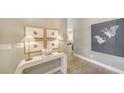 Bright entryway with stylish decor, wood-look floors, and serene artwork on the walls at 5856 Meriwether Pl, Sarasota, FL 34232