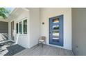 Contemporary style home features a blue front door, natural stone, and a modern window at 5856 Meriwether Pl, Sarasota, FL 34232