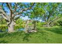 A peaceful backyard scene with a swing bench overlooking the lake, offering a serene retreat at 622 147Th E St, Bradenton, FL 34212
