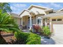 Close-up view of the home's facade showing a lovely front entrance with detailed architecture and landscaping at 622 147Th E St, Bradenton, FL 34212