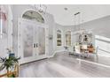 Bright entryway with soaring ceilings, stylish light fixtures, and a clear view into the formal dining area at 7257 Greystone St, Lakewood Ranch, FL 34202