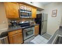 Kitchen featuring stainless steel appliances and light wood cabinets at 9100 Dr Martin Luther King Jr N St # 205, St Petersburg, FL 33702