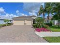 Charming home boasts manicured landscaping, brick pavers, and a welcoming entrance at 1017 Siberian Glen, Bradenton, FL 34212