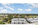An aerial view shows the property's proximity to a golf course and lush greenery at 1041 Capri Isles Blvd # 232, Venice, FL 34292
