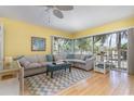Bright living room features large windows, neutral sectional sofa, and stylish decor for a comfortable living space at 1041 Capri Isles Blvd # 232, Venice, FL 34292