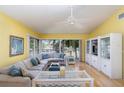 Bright living room featuring a comfortable sectional sofa, fan, and large windows at 1041 Capri Isles Blvd # 232, Venice, FL 34292