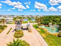Beautiful Tidewater Preserve entrance featuring a scenic water feature, lush landscaping and secure gate access at 1123 Riverscape St # D, Bradenton, FL 34208