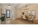 Bright dining room with wood floors, modern chandelier, and a decorative rug at 11606 Apple Tree Cir, Bradenton, FL 34211