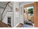 Charming entryway featuring a staircase, wine cooler, decorative shelving, and a welcoming 'Beach House' sign at 1163 Coquille St # 207, Sarasota, FL 34242