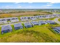 Aerial view of a neighborhood featuring new homes, mature trees, and well-maintained green spaces at 12557 Galapagos Ct, Venice, FL 34293
